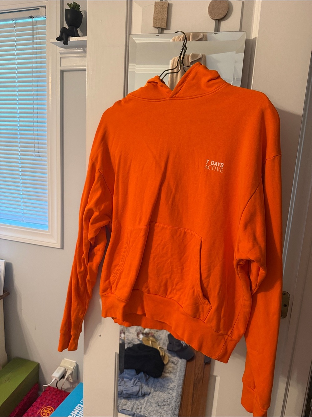 Men's Orange Pullover Hoodie with Subtle Chest Logo
